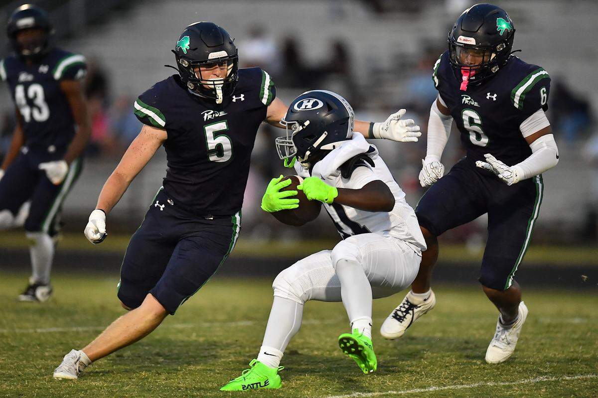 Heritage running back Brandon Hawkins (41) is defended by Leesville Road's Derek Schemenauer (5) and Gavin Lennon (6) during the first half. The Leesville Road Pride and the Heritage Huskies met in a football game in Raleigh, N.C. on September 5, 2025.
