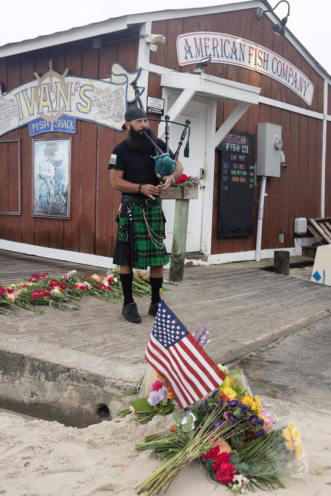Bagpiper Joey Whitaker plays "Amazing Grace" at a memorial at the American Fish Company in Southport, N.C. Sunday, Sept. 28, 2025.  Three people were killed and at least five injured when a person shot into the local nightspot from a boat Saturday night.