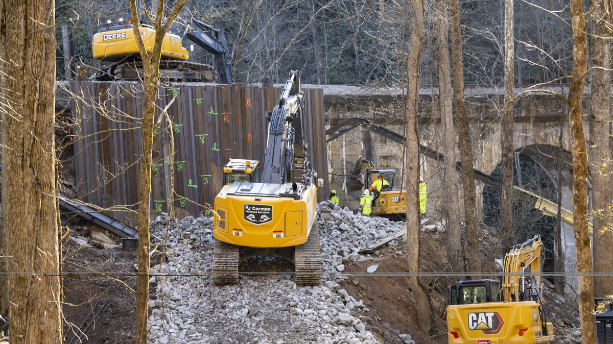 Crews work to repair a railroad bridge on a section of Norfolk Southern’s AS Line near Old Fort, east of Asheville, on Monday, Feb. 9, 2026. A 15-mile section of track, including a series of remote tunnels and horseshoe curves as it climbs and descends the Eastern Continental Divide, was severely damaged by the remnants of Hurricane Helene in 2024.