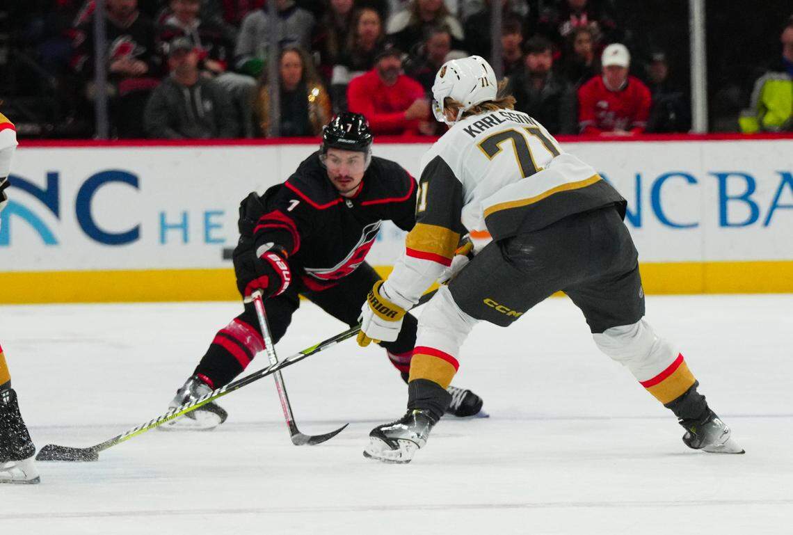 Dec 19, 2023; Raleigh, North Carolina, USA; Carolina Hurricanes defenseman Dmitry Orlov (7) defends against Vegas Golden Knights center William Karlsson (71) during the first period at PNC Arena. Mandatory Credit: James Guillory-USA TODAY Sports