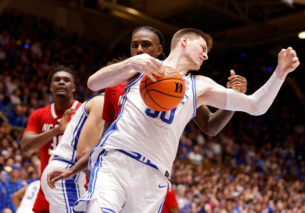Duke’s Kyle Filipowski pulls down a defensive rebound in front of N.C. State’s Greg Gantt during the first half of Duke’s 71-67 win over N.C. State on Tuesday, Feb. 28, 2023, at Cameron Indoor Stadium in Durham, N.C.