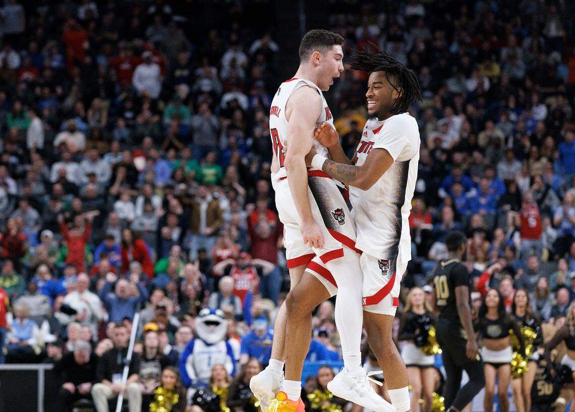 N.C. State’s Michael O’Connell and Jayden Taylor celebrate following the Wolfpack’s 79-73 overtime win against Oakland in the second round of the NCAA Tournament on Saturday, March 23, 2024, at PPG Paints Arena in Pittsburgh, Pa.