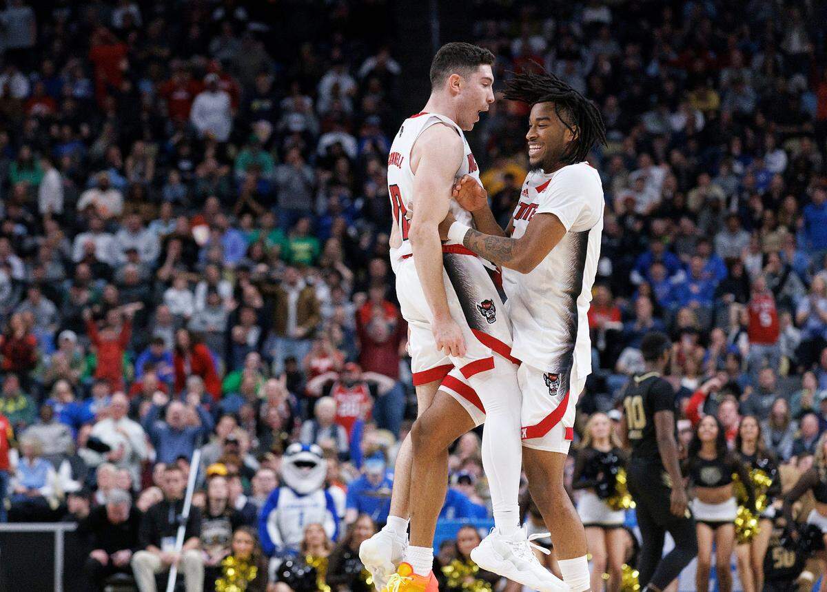 N.C. State’s Michael O’Connell and Jayden Taylor celebrate following the Wolfpack’s 79-73 overtime win against Oakland in the second round of the NCAA Tournament on Saturday, March 23, 2024, at PPG Paints Arena in Pittsburgh, Pa.