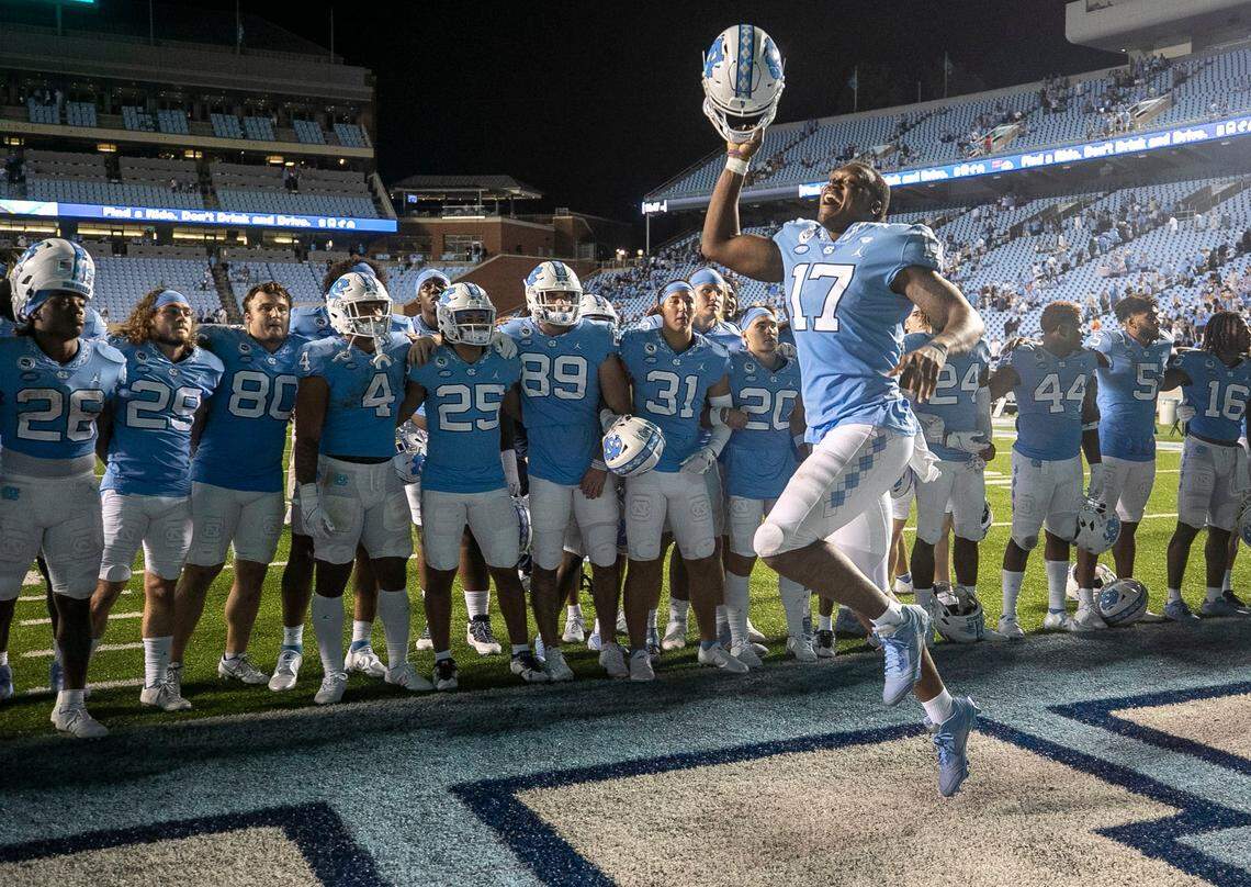 North Carolinas Chis Collins (17) celebrates the Tar Heels 56-24 victory over Florida A&M with teammate during the playing of the Alma Mater on Saturday, August 27, 2022 at Kenan Stadium in Chapel Hill, N.C.