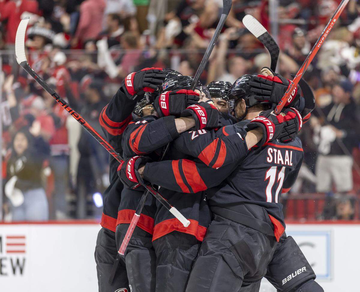Carolina Hurricanes center Jordan Staal (11) is surrounded by teammates after scoring to tie Vegas 3-3 in the third period in Game 2 of the Stanley Cup Final, on Thursday, June 4, 2026 at Lenovo Center in Raleigh, N.C.