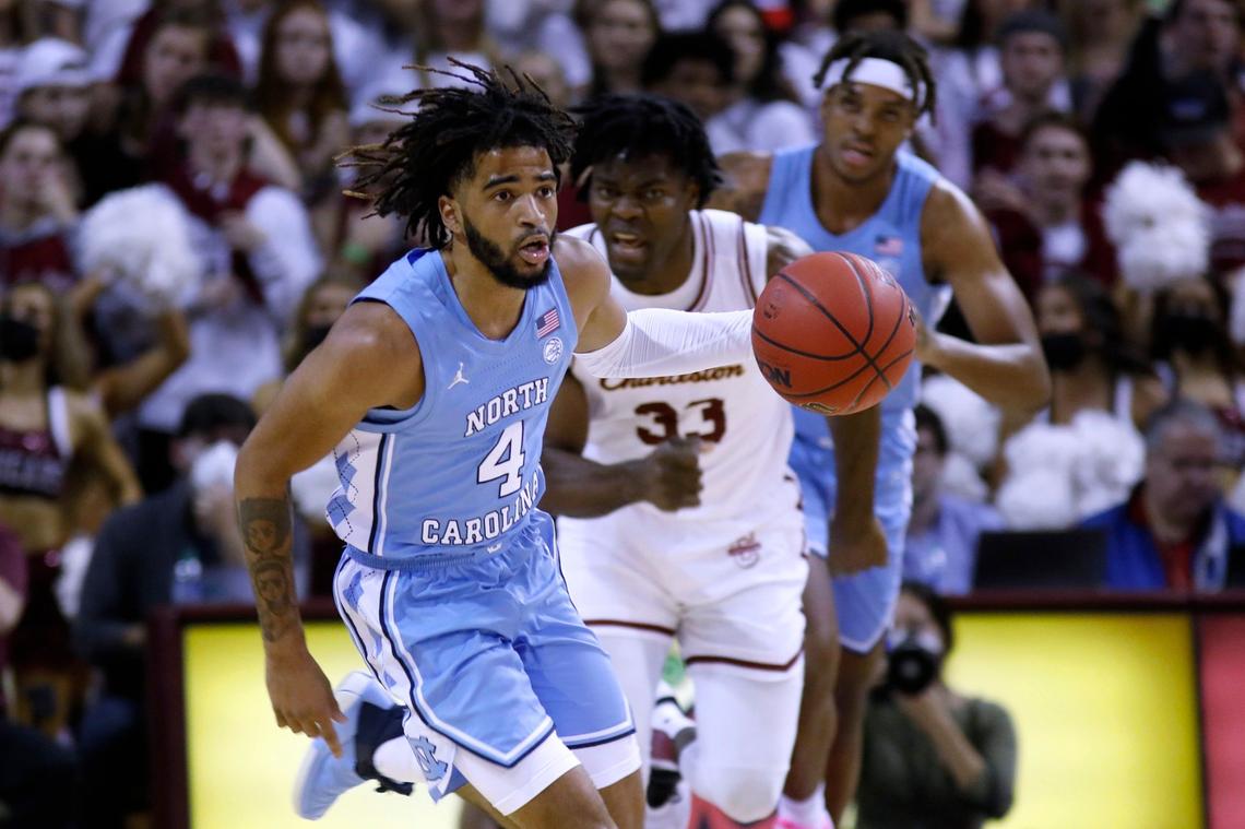 North Carolina’s RJ Davis (4) brings the ball up as College of Charleston’s Osinachi Smart (33) trails during the first half of an NCAA college basketball game Tuesday, Nov. 16, 2021, in Charleston, S.C. (AP Photo/Mic Smith)