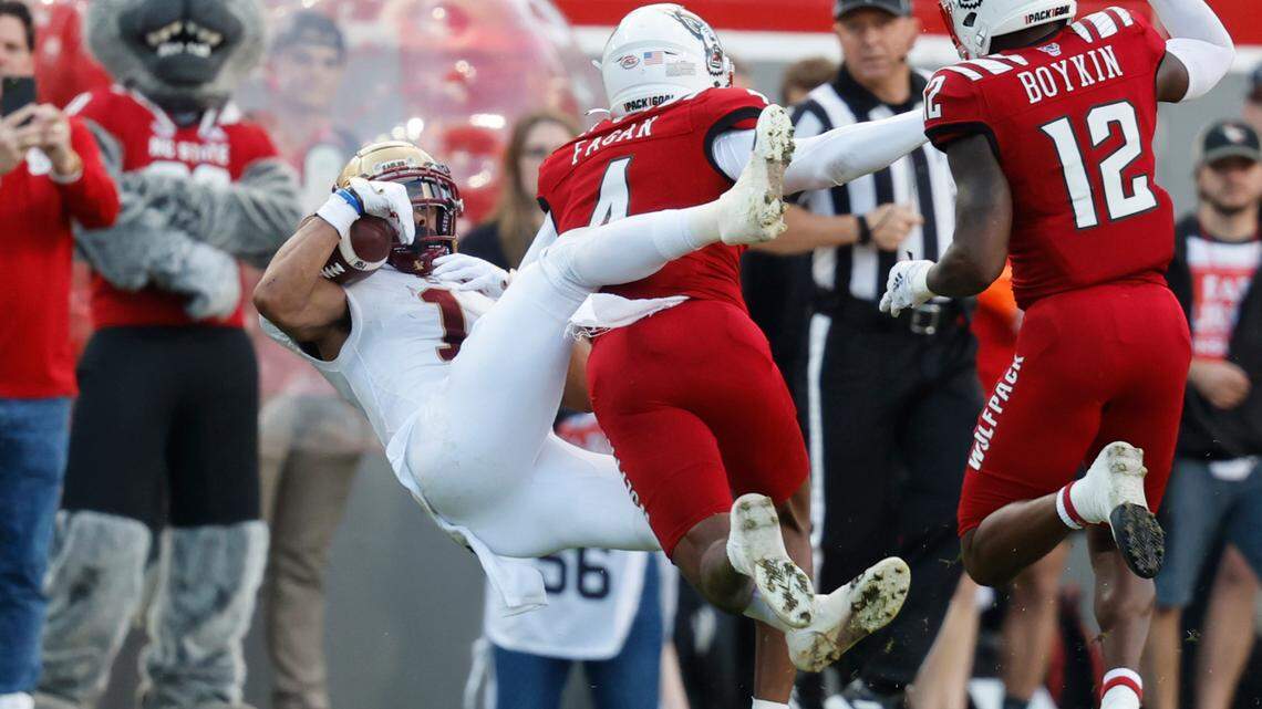 Boston College wide receiver Jaelen Gill (1) makes the reception while being hit by N.C. State safety Cyrus Fagan (4) during the first half of N.C. State’s game against Boston College at Carter-Finley Stadium in Raleigh, N.C., Saturday, Nov. 12, 2022.