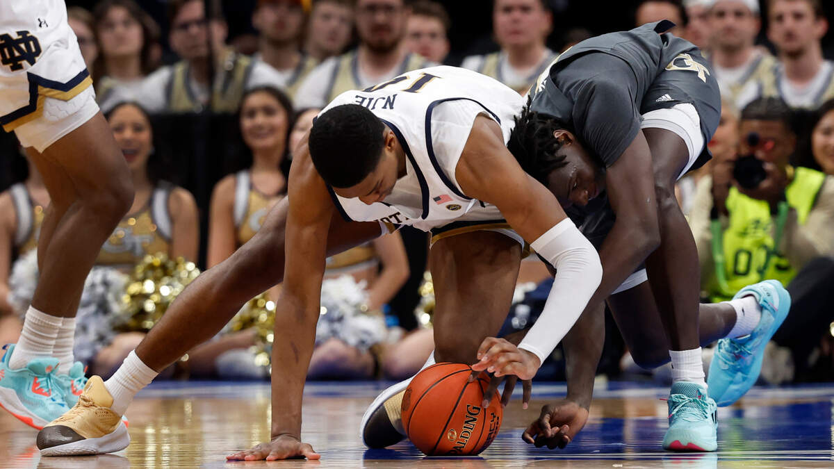 Notre Dame Fighting Irish forward Kebba Njie (14) and Georgia Tech Yellow Jackets forward Baye Ndongo (11) dive for a loose ball in the second half at Capital One Arena.