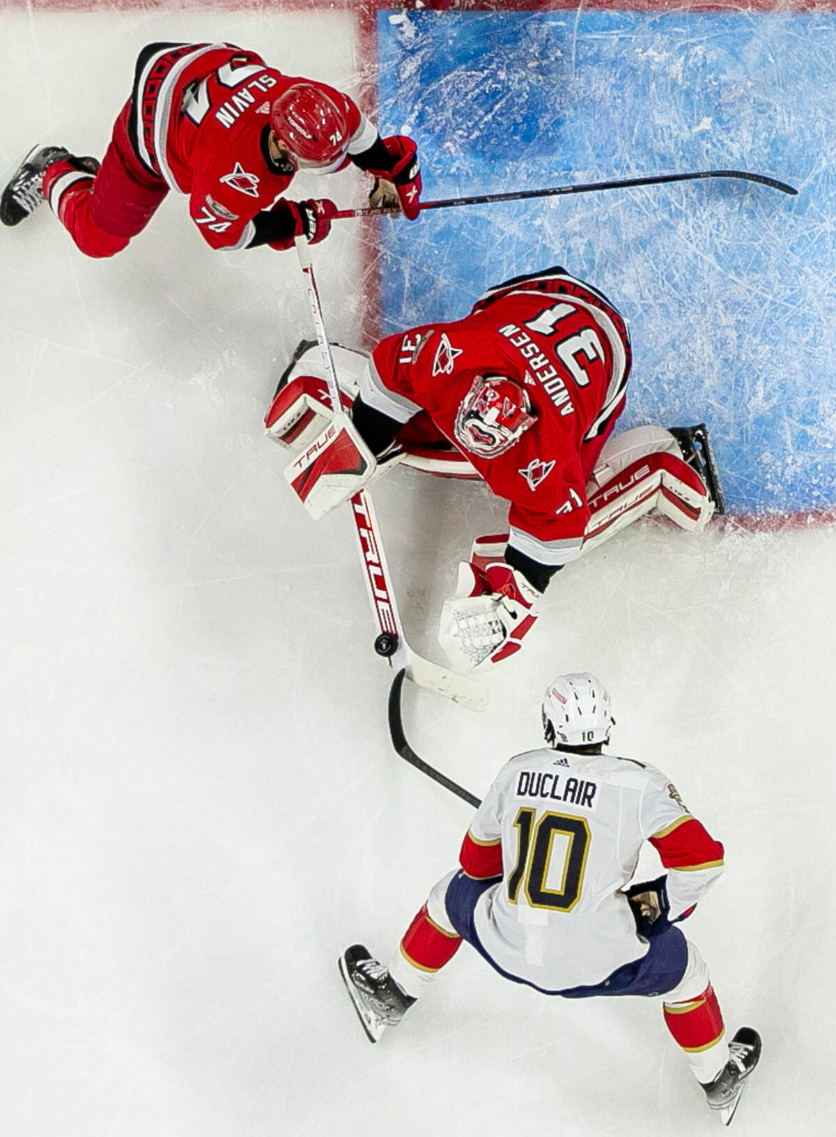 The Carolina Hurricanes Jaccob Slavin (74) backs up goalie Frederik Andersen (31) as he stops a scoring attempt by the Florida Panthers Anthony Duclair (10) in the first period during Game 1 of the Eastern Conference Finals on Thursday, May 18, 2023 at PNC Arena in Raleigh, N. C.