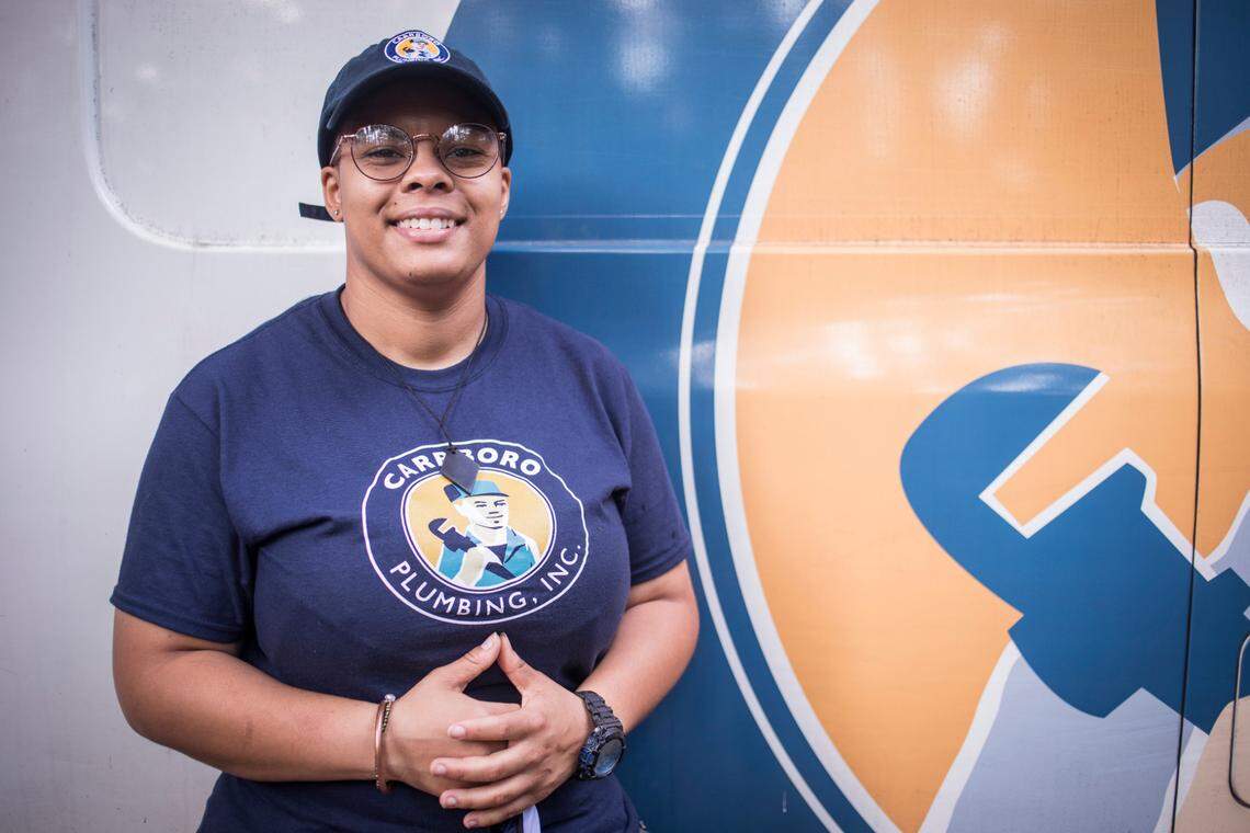 Jasmine Jones poses for a portrait in front of a Carrboro Plumbing, Inc. van at a home in Durham, N.C. where she was working on Tuesday, Sept. 29, 2020. Jones became employed with the company after participating in a trades training program at Hope Renovations in Carrboro, N.C., which is aimed at helping women learn trades that will lead to future employment.