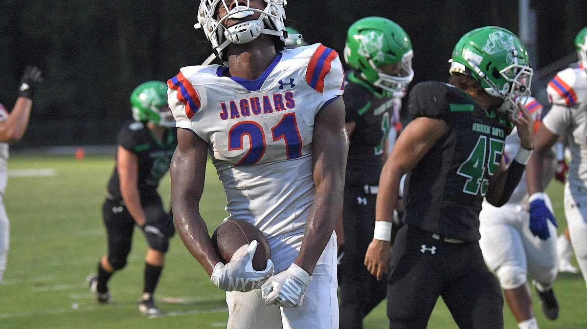 Athens Drive running back Ty Nicholson (21) reacts after running the touchdown against Cary during the first half. The Cary Imps and the Athens Drive Jaguars met in a football game in Cary, N.C. on September 6, 2024. Athens Drive wins 28-13.