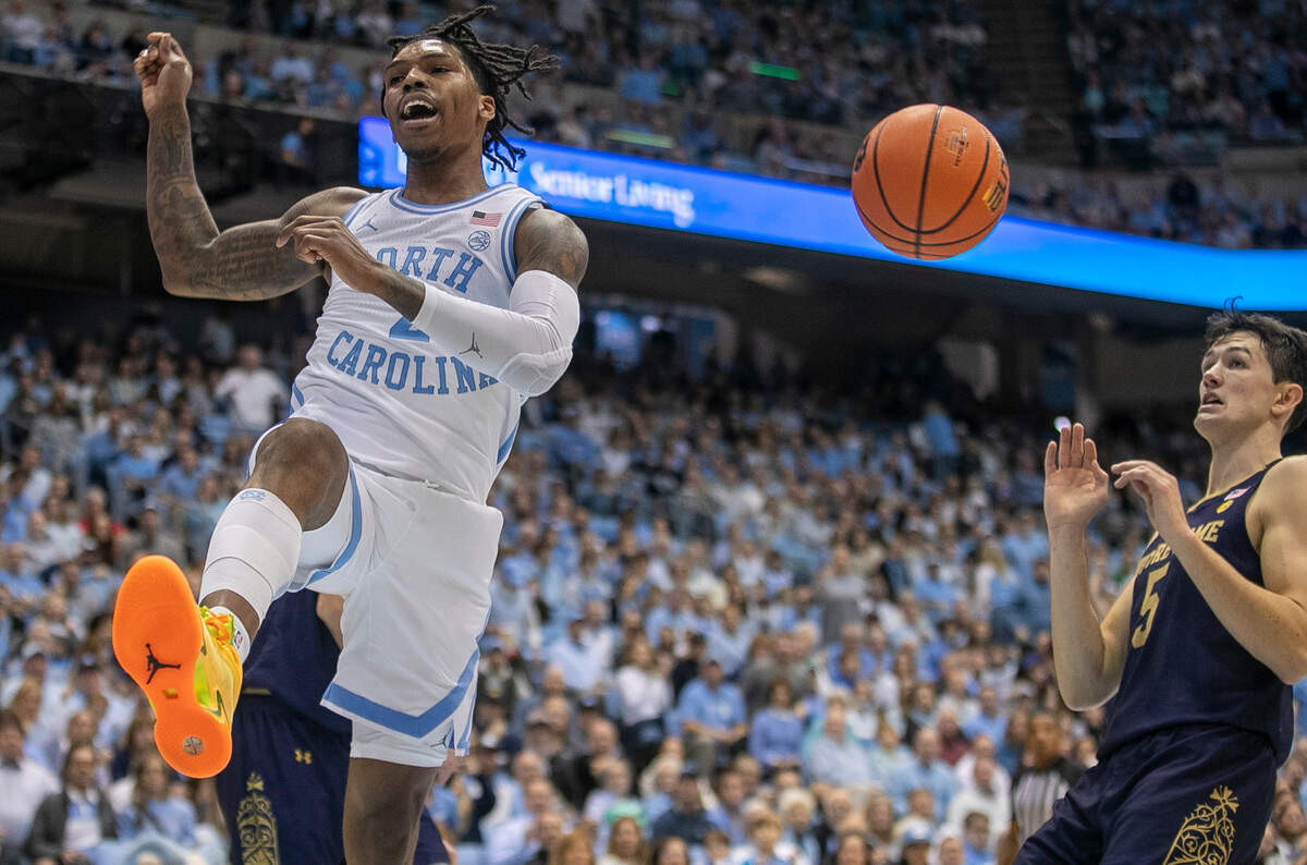 North Carolina’s Caleb Love (2) reacts after a dunk against Notre Dame’s Nate Laszewski (14) during the first half on Saturday, January 7, 2023 at the Smith Center in Chapel Hill, N.C.