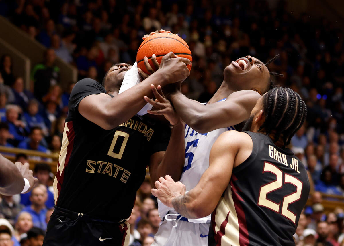 Duke’s Mark Mitchell gets tangled up with Florida State’s Chandler Jackson and Darin Green Jr. during the second half of a men’s basketball game at Cameron Indoor Stadium on Saturday, Dec. 31, 2022, in Durham, N.C.