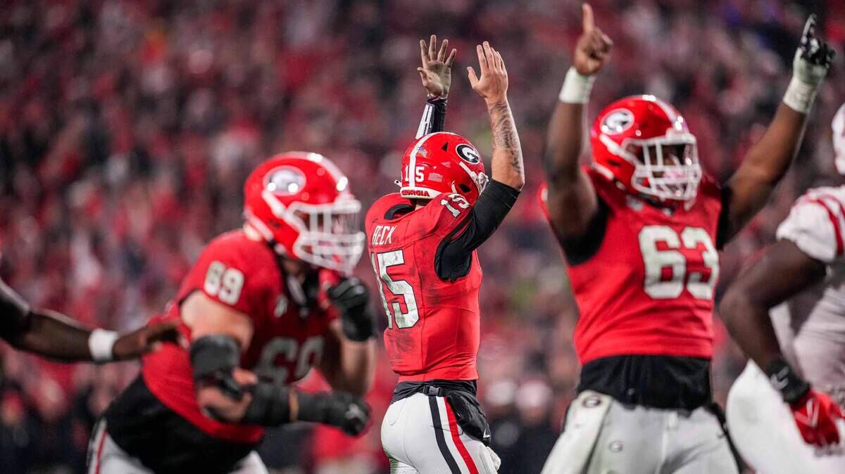 Nov 11, 2023; Athens, Georgia, USA; A Georgia Bulldogs quarterback Carson Beck (15) reacts after throwing a touchdown pass against the Mississippi Rebels during the second half at Sanford Stadium.
