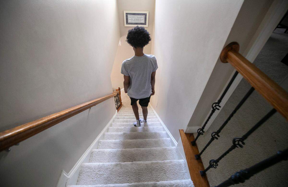 After retrieving the final items from his bedroom, Jarin Stevenson descends the stairs in his Chapel Hill home for the last time before departing for Tuscaloosa, Ala., on Wednesday, June 28, 2023. 