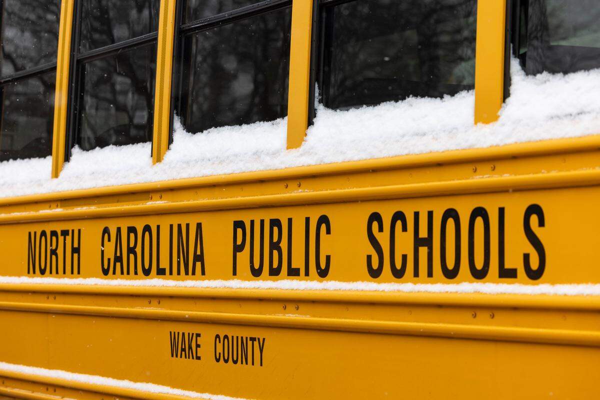 Snow covered buses at Southeast Raleigh Magnet High School, after a winter storm moved through North Carolina on Thursday afternoon February 20, 2025 in Raleigh, N.C.