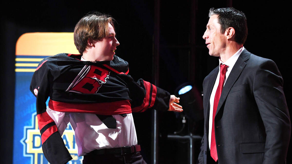 Carolina Hurricanes draft pick Bradly Nadeau talks with head coach Rod BrindAmour after being selected with the thirtieth pick in round one of the 2023 NHL Draft at Bridgestone Arena.