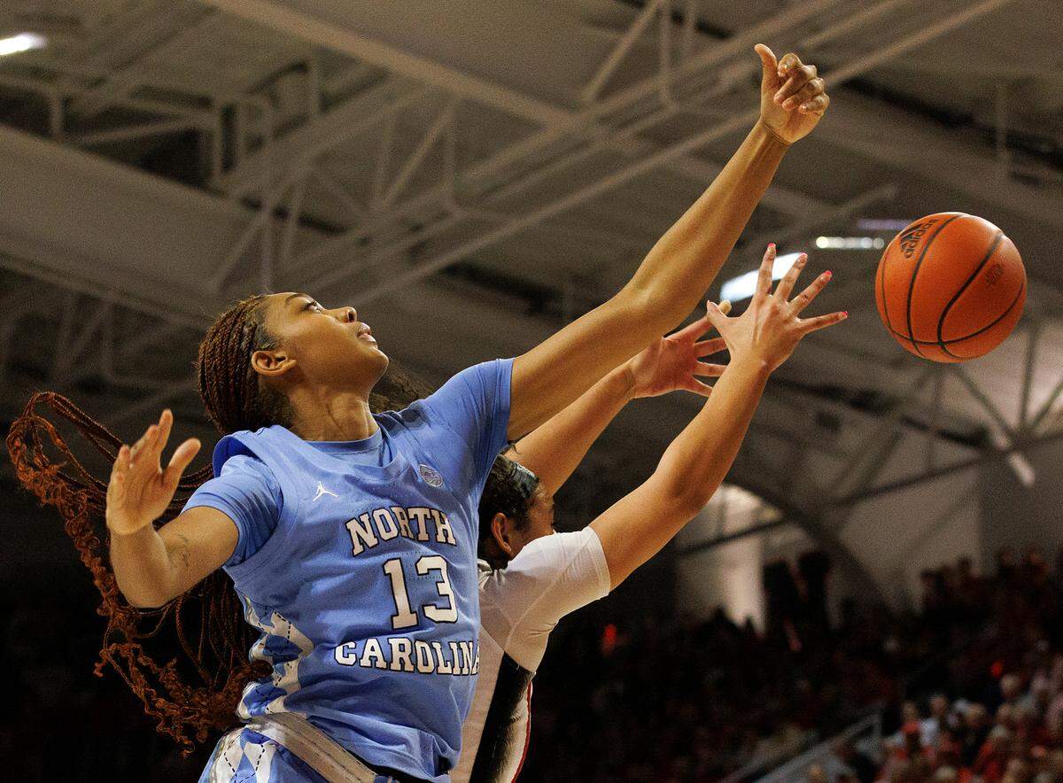 North Carolina’s Teonni Key and N.C. State’s Mimi Collins vie for a loose ball during the first half of the Wolfpack’s 63-59 win on Thursday, Feb. 1, 2024, at Reynolds Coliseum in Raleigh, N.C.
