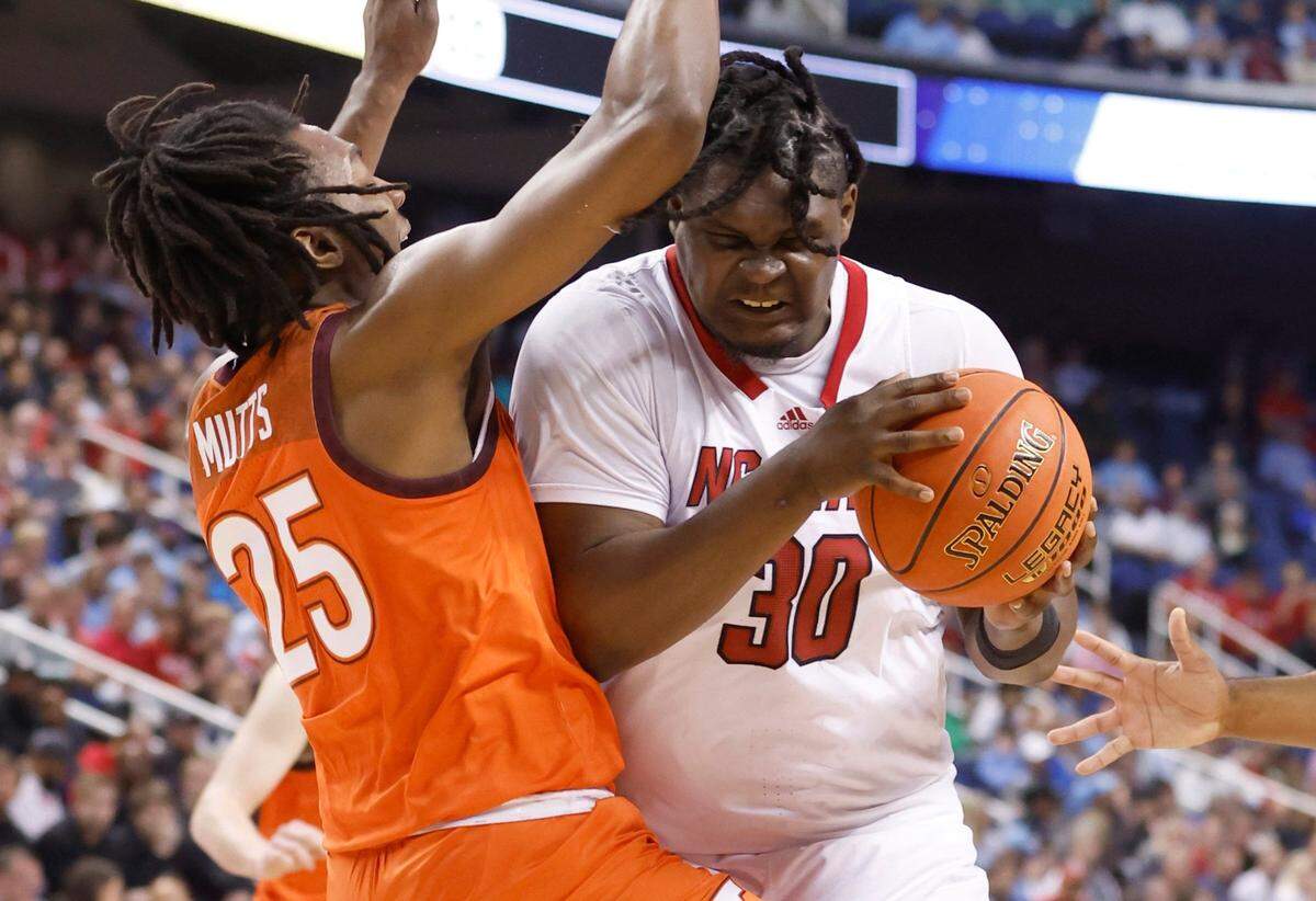 N.C. State’s D.J. Burns Jr. (30) is called for the foul as he runs into Virginia Tech’s Justyn Mutts (25) during the first half of N.C. State’s game against Virginia Tech in the second round of the ACC Men’s Basketball Tournament in Greensboro, N.C., Wednesday, March 8, 2023.