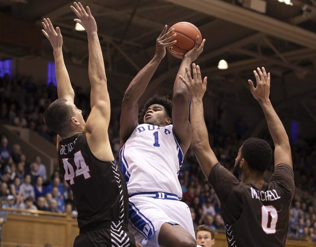 Duke’s Vernon Carey Jr. (1) puts up a shot against Brown’s David Mitchell (0) and Matt DeWolf (44) during the first half on Saturday, December 28, 2019 at Cameron Indoor Stadium in Durham, N.C.