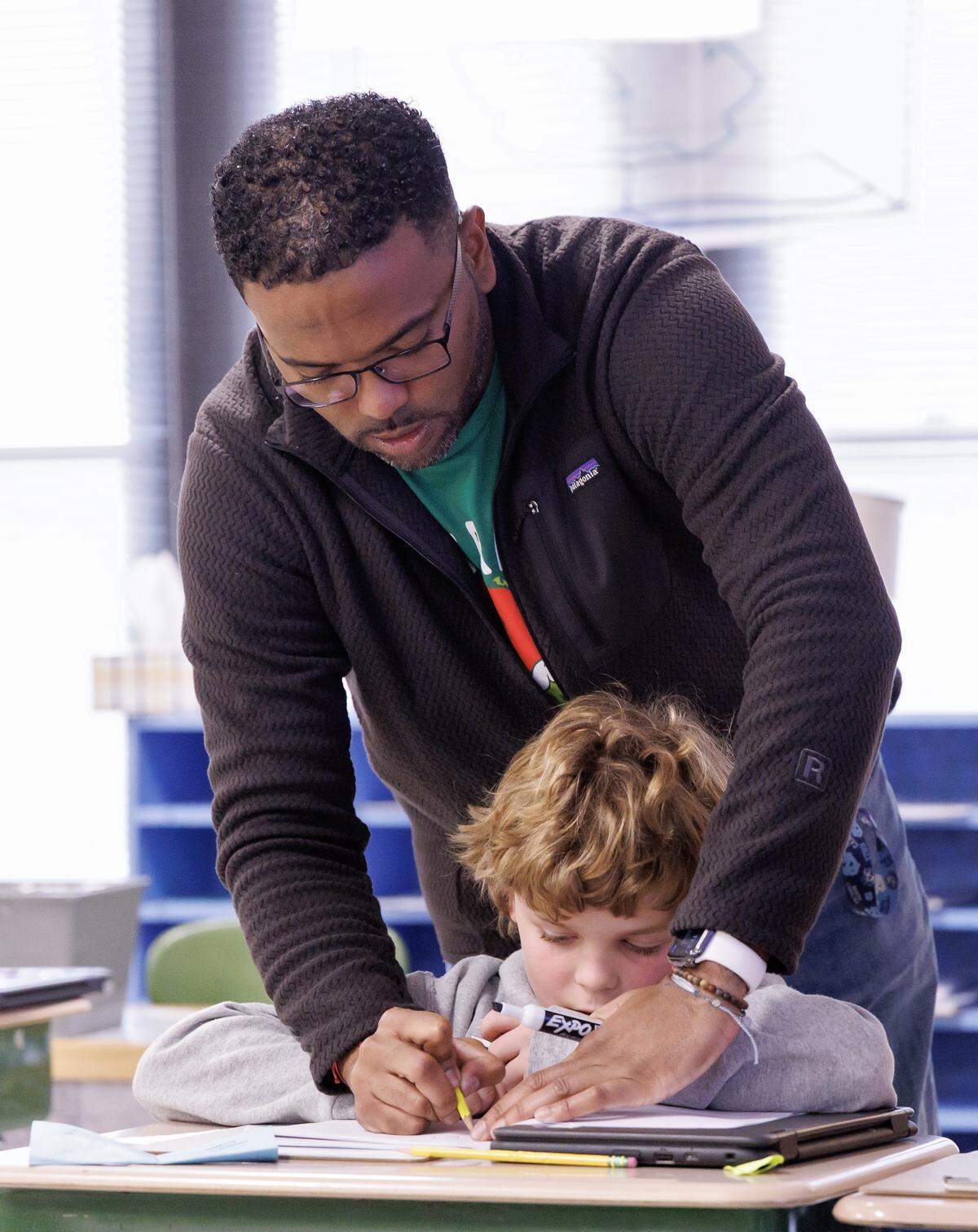 Pittsboro Elementary School fourth-grade teacher Shane Henderson, who recently won the Milken Educator Award, works with Cullen Finnan. 