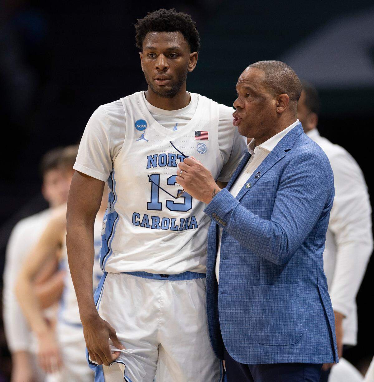 North Carolina coach Hubert Davis talks with Jalen Washington (13) in the first half against Wagner on Thursday, March 21, 2024 during the NCAA Tournament at Spectrum Center in Charlotte, N.C.