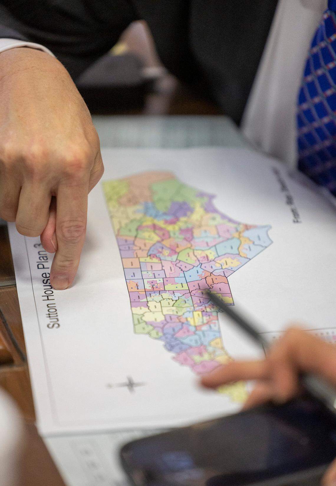 Rep. Mitchell S. Setzer, who represents Catawba and Iredell Counties looks over a redistricting map during debate of House Bill 898 on Tuesday, October 24, 2023 in Raleigh, N.C.