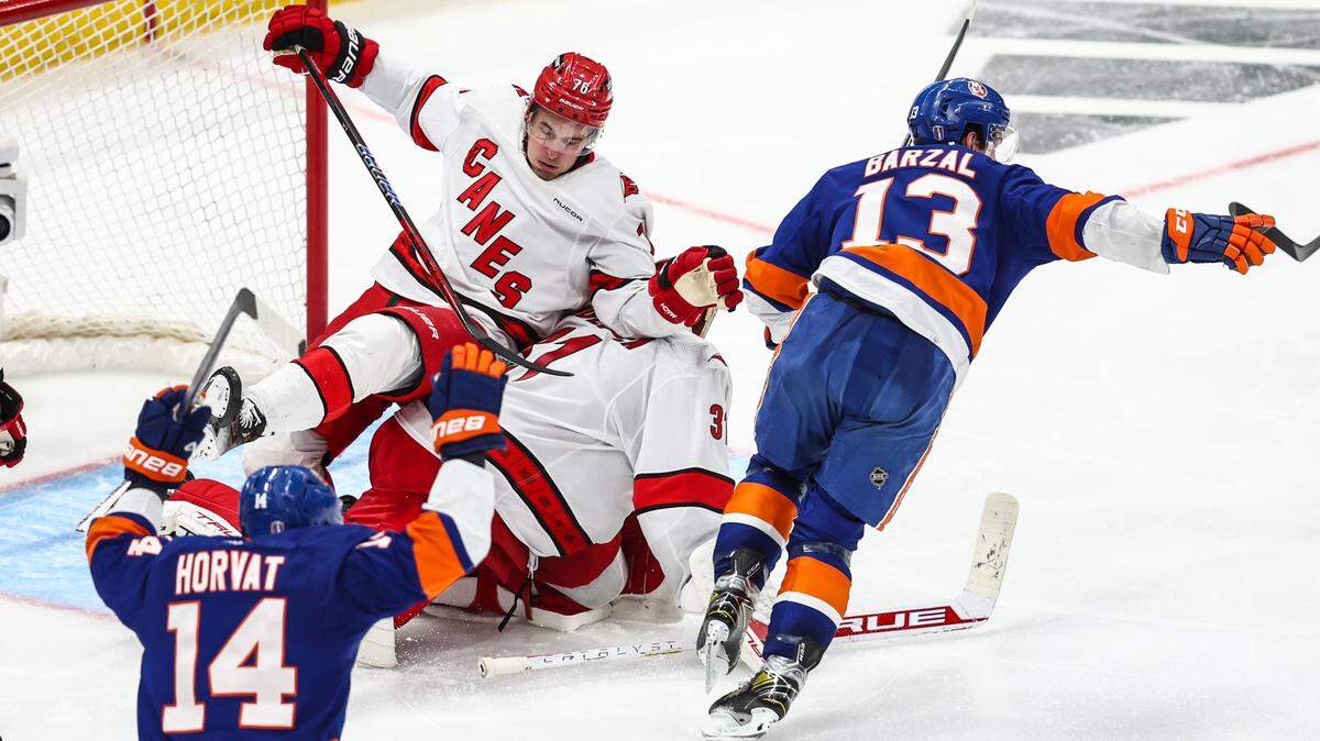 New York Islanders center Mathew Barzal (13) skates towards his teammates after scoring the game winning goal in the second overtime against the Carolina Hurricanes in game four of the first round of the 2024 Stanley Cup Playoffs at UBS Arena.