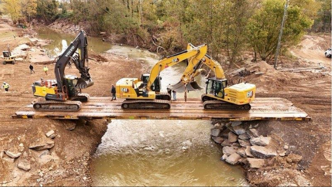 Innovative Bridge Co. of Tennessee installed a temporary bridge over the Swannanoa River in Asheville made of old railroad flat cars on Oct, 15, 2024.