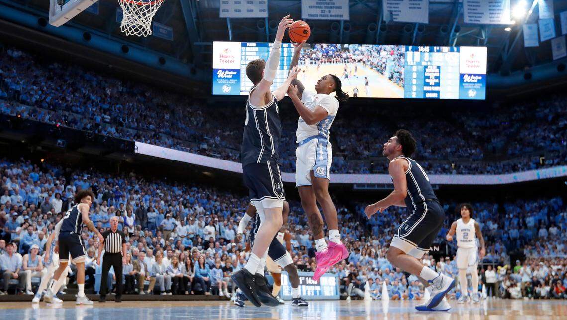 North Carolina’s Armando Bacot (5) shoots as Duke’s Kyle Filipowski (30) defends during UNC’s 93-84 victory over Duke at the Smith Center in Chapel Hill, N.C., Saturday, Feb. 3, 2024.