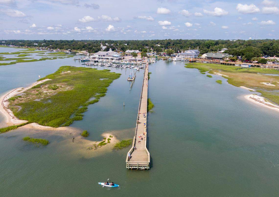 Murrells Inlet has seen rapid commercial development and tourism business along its Marsh Walk. Drone images of Murrells Inlet and Garden City Beach S.C. during high tide. Aug. 11, 2021.