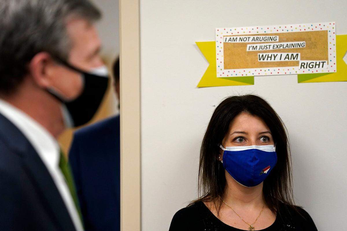 Gov. Roy Cooper, left, answers questions Thursday, Jan. 28, 2021 in Pittsboro, N.C. while Secretary of the N.C. Department Health and Human Services Dr. Mandy Cohen listens at right during a tour of Piedmont Health Senior Care, a federally qualified health center where PACE patients (Program of All-Inclusive Care for the Elderly) and underserved populations are receiving the COVID-19 vaccine.