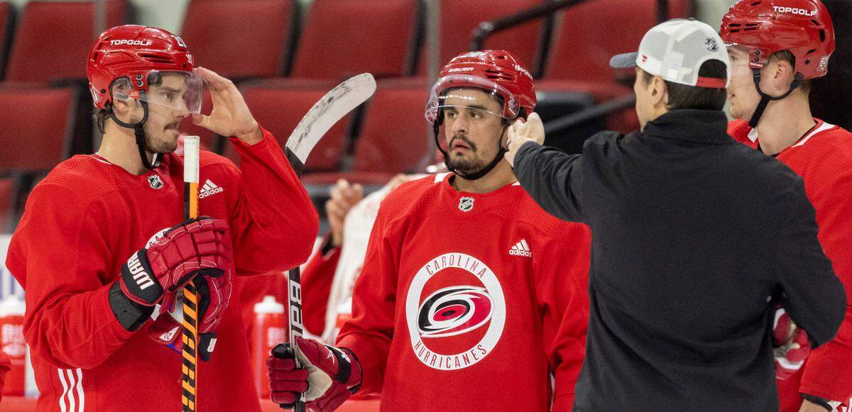 Carolina Hurricanes coach Rod Brind’Amour talks with Sebastian Aho (20), Seth Jarvis (24) and Martin Necas (88) during their practice on Monday, May 15, 2023 at PNC Arena in Raleigh, N.C.