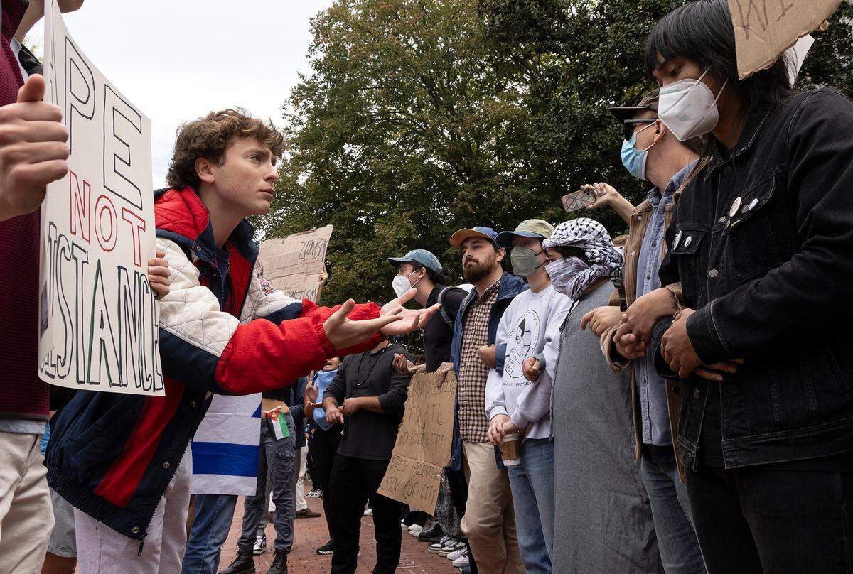 Counter-protesters and Pro-Palestinian demonstrators interact during a rally in support of Palestinians at UNC-Chapel Hill on Thursday, Oct. 12, 2023. The rally was organized by the UNC chapter of Students for Justice in Palestine.