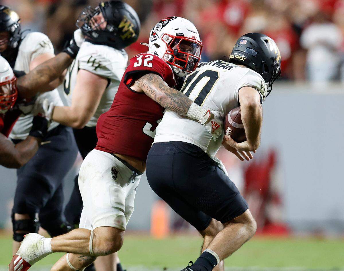 N.C. State linebacker Drake Thomas (32) sacks Wake Forest quarterback Sam Hartman (10) during the second half of N.C. State’s 30-21 victory over Wake Forest at Carter-Finley Stadium in Raleigh, N.C., Saturday, Nov. 5, 2022.