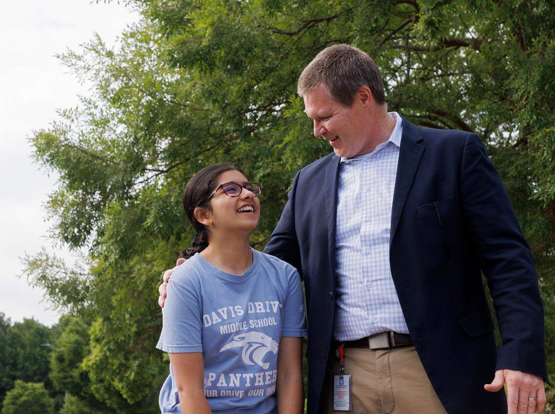 Davis Drive Middle School seventh-grader Ananya Rao Prassanna smiles as she is greeted by Principal Michael Hokenberg during a celebration on Monday, June 3, 2024, in Cary, N.C. honoring Prassanna’s third-place finish in the Scripps National Spelling Bee.
