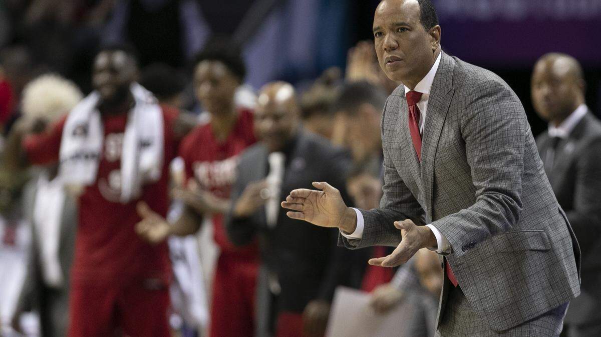 N.C. State coach Kevin Keatts reacts applauds his team as they take a lead over Virginia during the first half on Thursday, March 13, 2019 during quarter finals of the ACC Tournament at Spectrum Center in Charlotte, N.C.