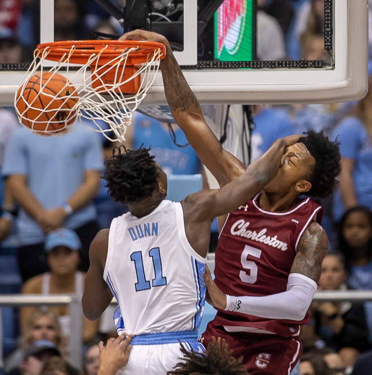 Charleston’s Raekwon Horton (5) dunks over North Carolina’s D’Marco Dunn (11) during the first half on Friday, November 11, 2022 at the Smith Center in Chapel Hill, N.C.