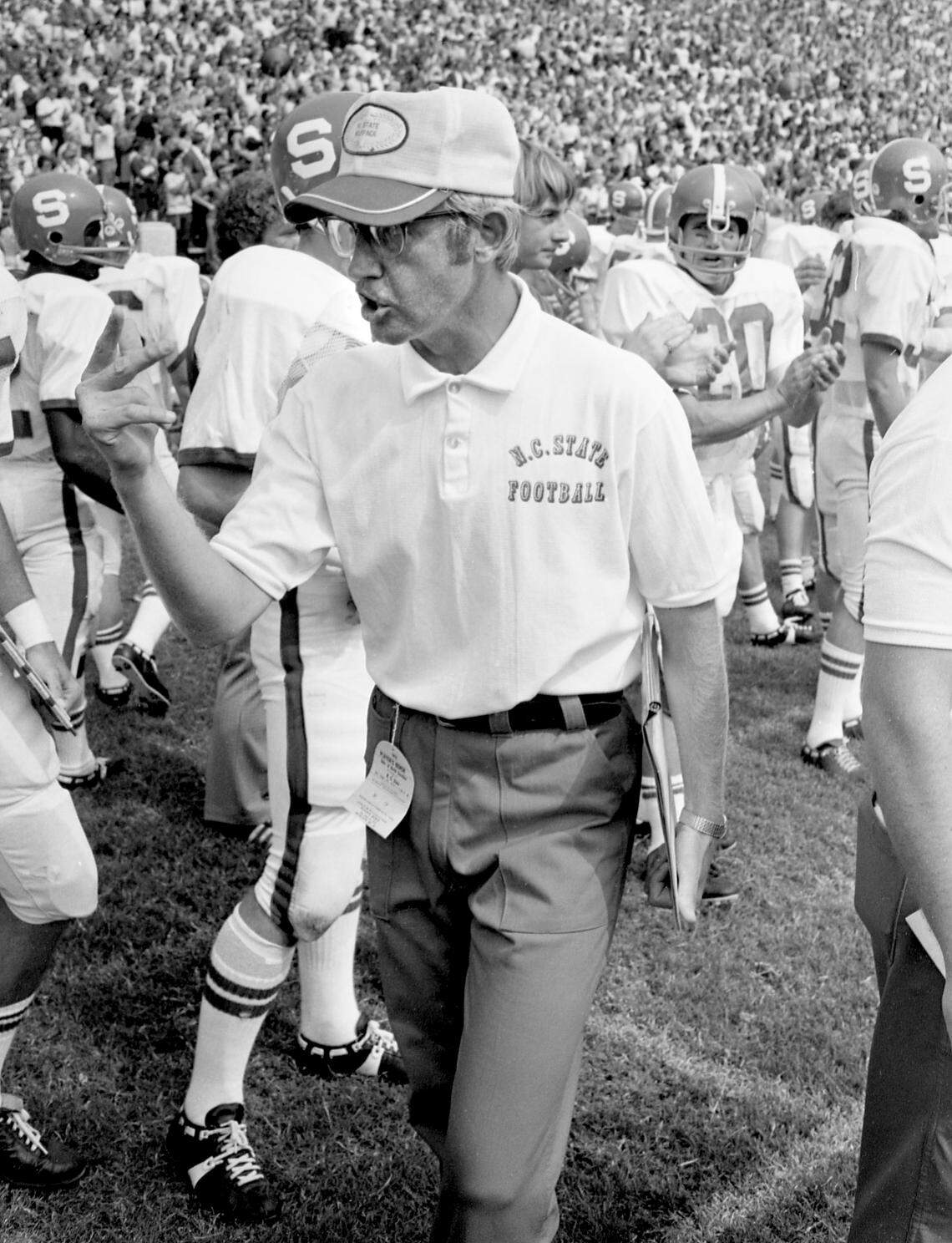 N.C. State football coach Lou Holtz calls out instructions on the sidelines at a 1972 Wolfpack game.