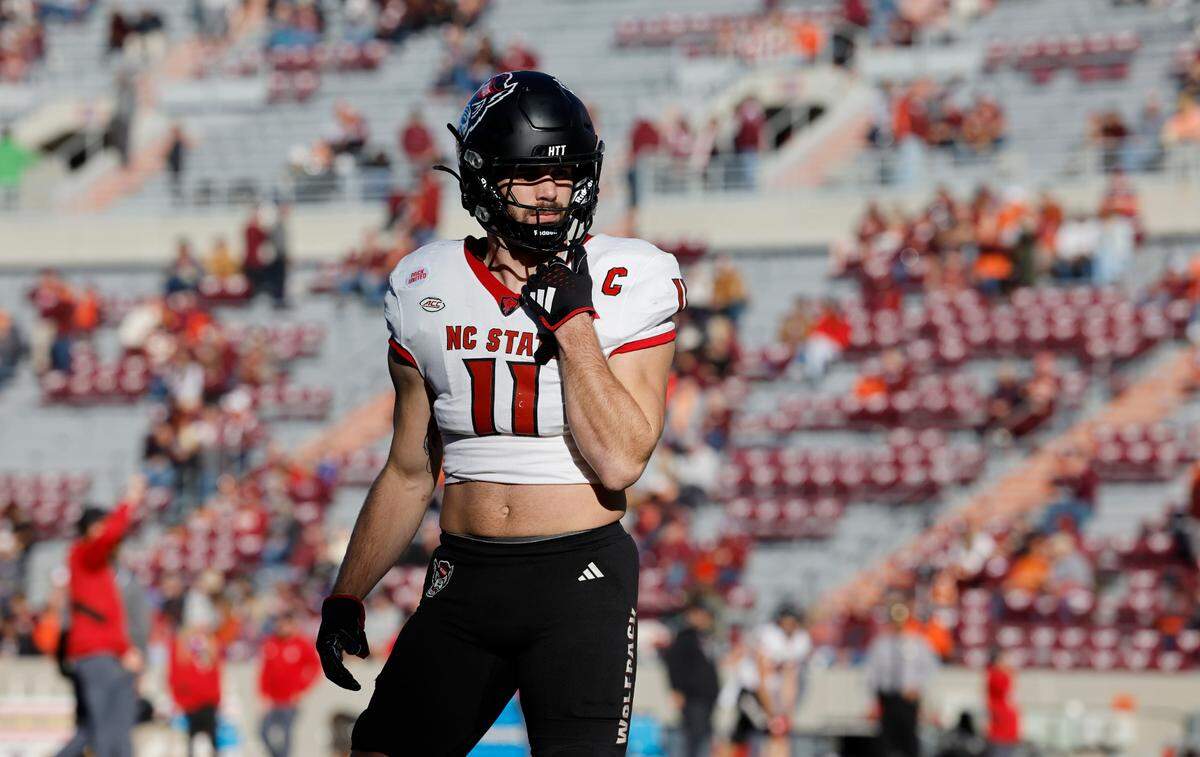 N.C. State linebacker Payton Wilson (11) warms up before N.C. State’s game against Virginia Tech at Lane Stadium in Blacksburg, VA, Saturday, Nov. 18, 2023.