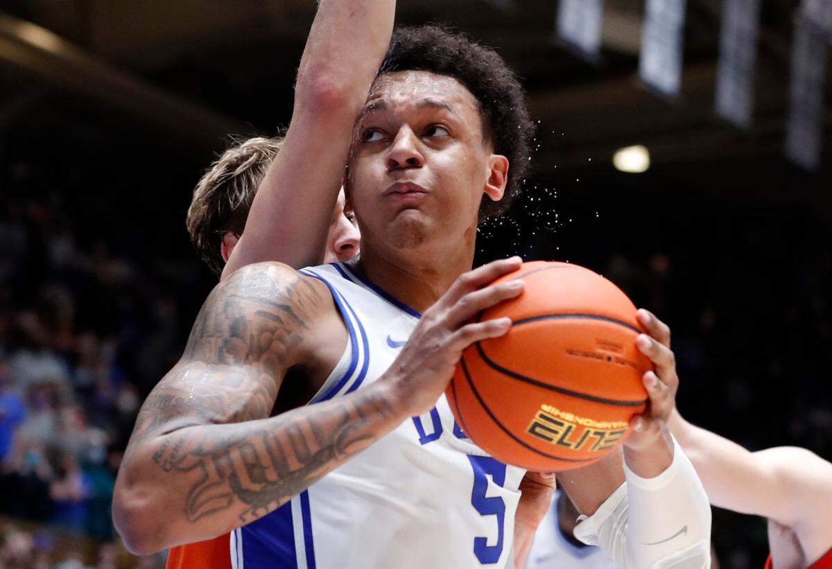Duke’s Paolo Banchero (5) drives around Clemson’s Hunter Tyson (5) to score with ten seconds left in the game during Duke’s 71-69 victory over Clemson at Cameron Indoor Stadium in Durham, N.C., Tuesday, January 25, 2022.