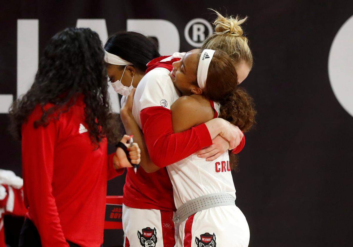 N.C. State’s Elissa Cunane (33) hugs Kai Crutchfield after Crutchfield came off the court after being recognized near the end of N.C. State’s 83-53 victory over Pittsburgh at Reynolds Coliseum in Raleigh, N.C., Thursday, February 25, 2021.
