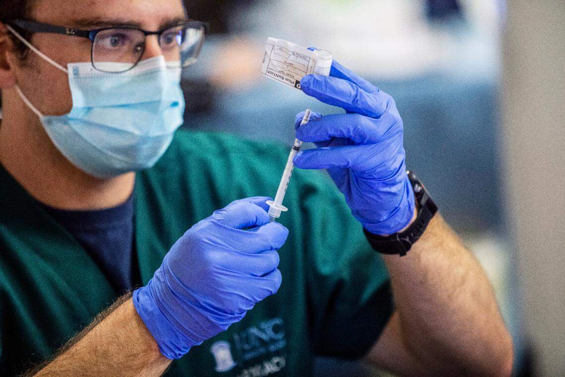Pharmacy technician Cody Close prepares a dose of COVID-19 vaccine at UNC Health in Chapel Hill, NC Thursday, Dec. 7, 2020 where frontline healthcare workers are among some of the first recipients of the Pfizer COVID-19 vaccine.