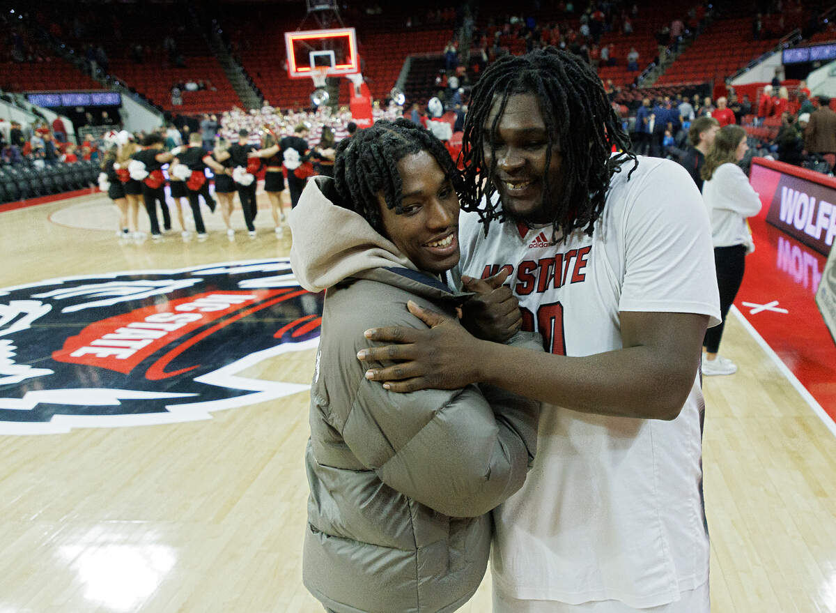 N.C. State’s DJ Burns Jr. embraces former teammate Terquavion Smith following the Wolfpack’s 83-66 win over Detroit on Saturday, Dec. 23, 2023, at PNC Arena in Raleigh, N.C.