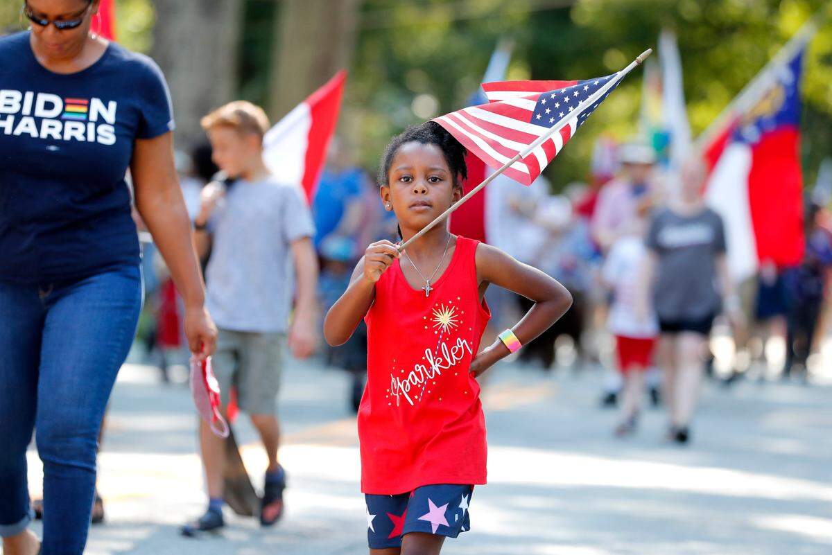Brenna Alston, 6, marches in the Watts-Hillandale neighborhood’s 72nd annual Fourth of July parade in Durham, N.C, Sunday, July 4, 2021.