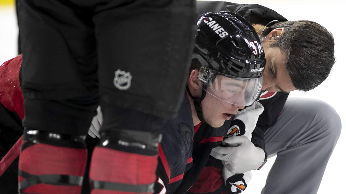 Carolina Hurricanes’ Andrei Svechnikov (37) is attended to after being knocked to the ice during a fight with Washington’s Alex Ovechkin during the first period on Monday, April 15, 2019 at the PNC Arena on Raleigh, N.C.