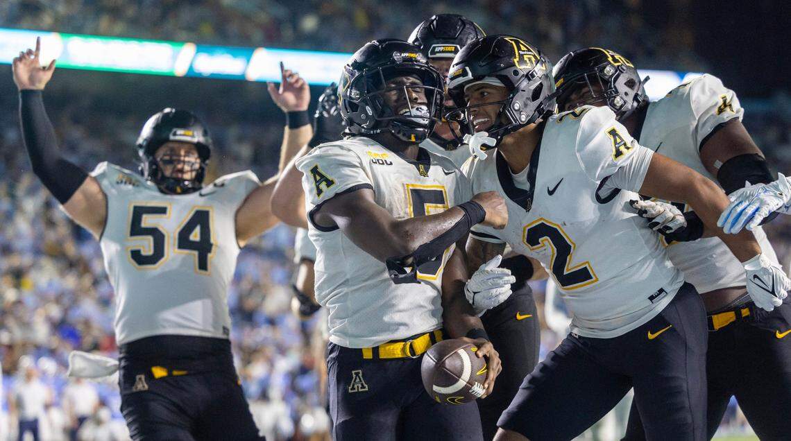 Appalachian State running back Nate Noel (5) celebrates with teammates after scoring a touchdown on a 7-yard carry to take a 33-27 lead over North Carolina in overtime on Saturday September 9, 2023 at Kenan Stadium in Chapel Hill, N.C. 