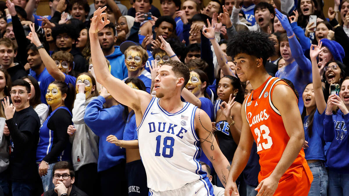 Duke’s Mason Gillis (18) celebrates a three-pointer in front of Miami’s Austin Swartz (23) during the first half of Duke’s game against Miami at Cameron Indoor Stadium in Durham, N.C., Tuesday, Jan. 14, 2025.