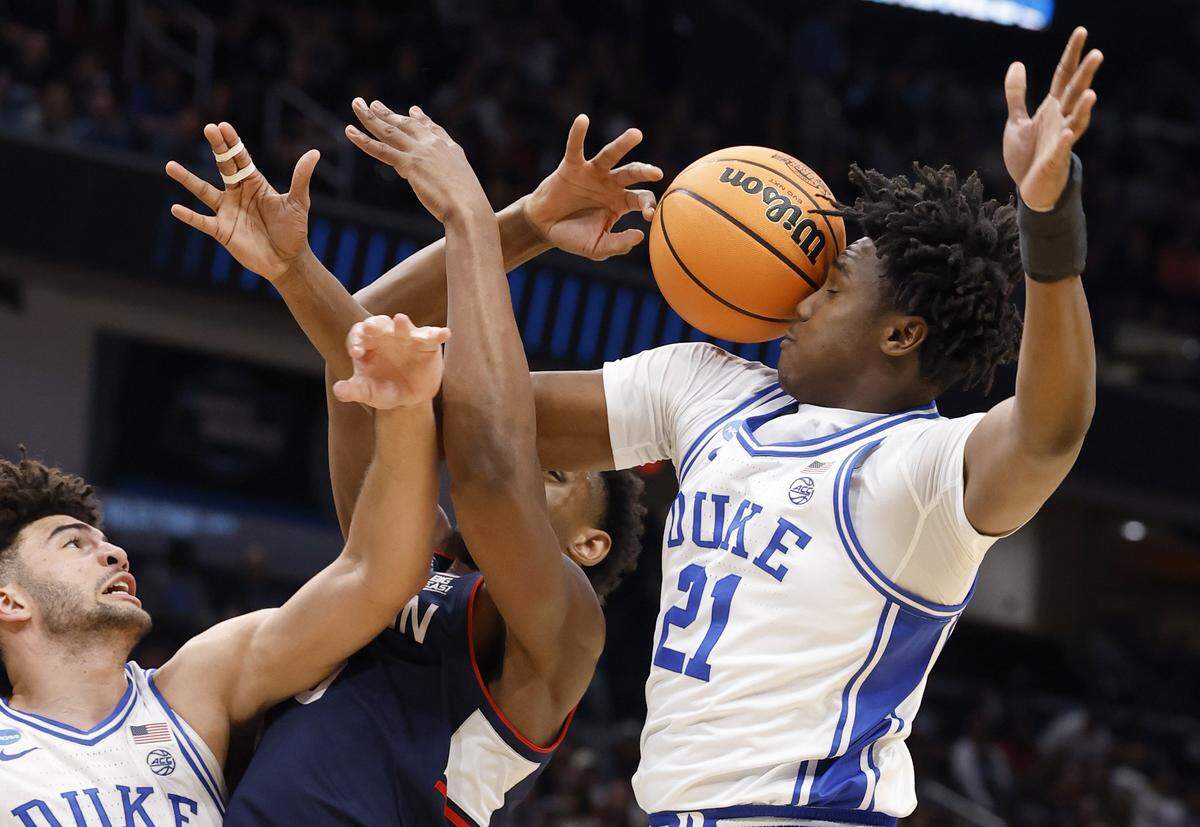 Duke’s Patrick Ngongba II (21) and UConn's Tarris Reed Jr. (5) go for a rebound during the first half of Duke’s game against Connecticut in the NCAA Men’s Tournament East Regional Final at Capital One Arena in Washington, D.C., Sunday, March 29, 2026.