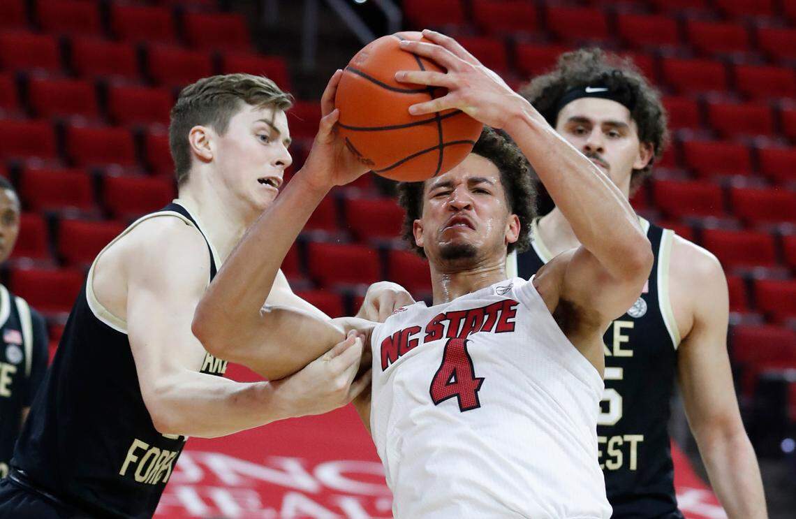 Wake Forest’s Jonah Antonio (20) fouls N.C. State’s Jericole Hellems (4) during the first half of N.C. State’s game against Wake Forest at PNC Arena in Raleigh, N.C., Wednesday, January 27, 2021.
